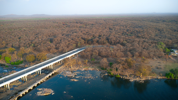 Orchha India 08 May 2026 Aerial view of a modern bridge crossing the Betwa River adjacent to a dense forest under a clear sky. Orchha India 08 May 2026 Aerial view of a modern bridge crossing the Betwa River adjacent to a dense forest under a clear sky.