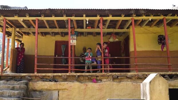 View of children on a porch of a traditional house in Nepal. View of children on a porch of a traditional house in Nepal.