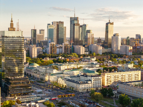 Aerial view of the modern skyline featuring the Palace of Culture and Science and Varso Tower during golden hour in Warsaw Poland. Aerial view of the modern skyline featuring the Palace of Culture and Science and Varso Tower during golden hour in Warsaw Poland.