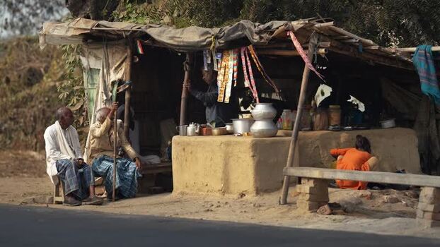 View of a roadside tea stall with elderly men in Patna India.