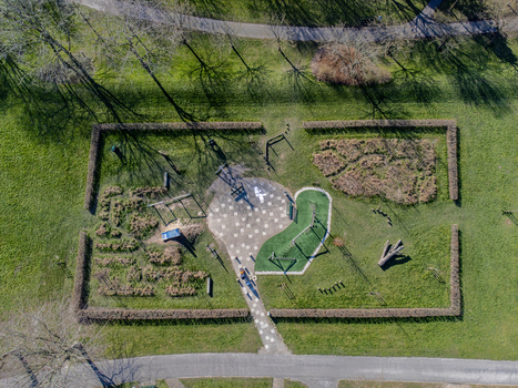 Aerial view of the Muzenpark Speeltuin s playground with its vibrant green turf contrasting against the muted browns of the surrounding foliage Almere Flevoland Netherlands. Aerial view of the Muzenpark Speeltuin s playground with its vibrant green turf contrasting against the muted browns of the surrounding foliage Almere Flevoland Netherlands.