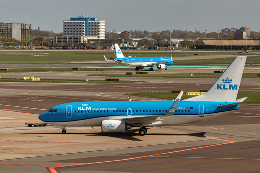 Schiphol Netherlands 16 April 2026 View of KLM Royal Dutch Airlines Boeing 737 aircraft taxiing on the tarmac at Schiphol Airport with another plane and airport buildings in the background. Schiphol Netherlands 16 April 2026 View of KLM Royal Dutch Airlines Boeing 737 aircraft taxiing on the tarmac at Schiphol Airport with another plane and airport buildings in the background.