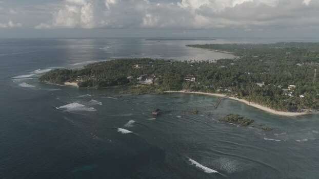 Aerial view of Cloud 9 Beach Club and coastline in Philippines. Aerial view of Cloud 9 Beach Club and coastline in Philippines.