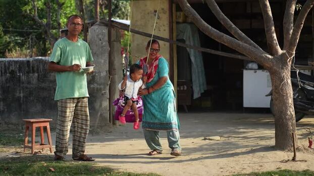 View of a family with a child on a swing Nepal. View of a family with a child on a swing Nepal.