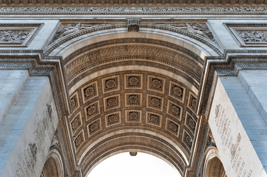 View of the intricate stone carvings and coffered ceiling under the arch of the Arc de Triomphe in Paris Ile de France France.