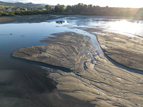 Aerial view of Lake Czorsztynskie with exposed sandbanks and low water levels under golden hour light in Nowy Targ County Lesser Poland Voivode Poland. Aerial view of Lake Czorsztynskie with exposed sandbanks and low water levels under golden hour light in Nowy Targ County Lesser Poland Voivode Poland.