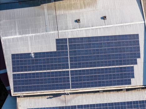 Aerial view of solar panels installed on a corrugated metal roof in Porto Porto District Portugal.