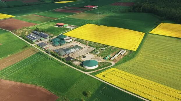 Aerial view of a biogas plant and rapeseed fields Germany.