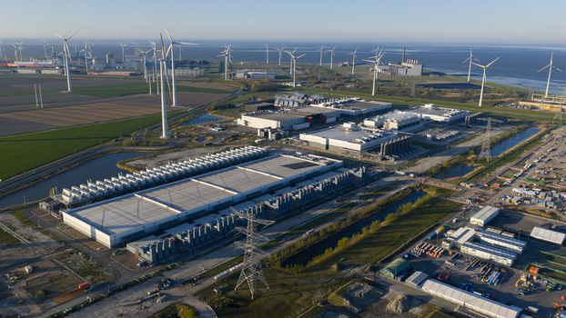 Aerial view of the Google Data Center surrounded by wind turbines and industrial infrastructure in Eemshaven Groningen Netherlands. Aerial view of the Google Data Center surrounded by wind turbines and industrial infrastructure in Eemshaven Groningen Netherlands.