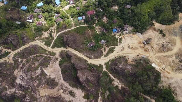 Aerial view of rural village and dirt road in Papua Indonesia.
