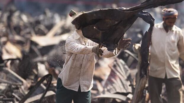 View of men working in a scrapyard with metal debris Bangladesh. View of men working in a scrapyard with metal debris Bangladesh.