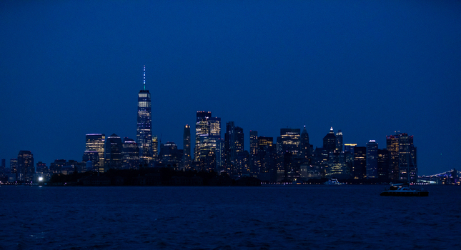 New York New York United States 08 July 2021 View of the illuminated Manhattan skyline at night featuring One World Trade Center rising above the dense urban architecture. New York New York United States 08 July 2021 View of the illuminated Manhattan skyline at night featuring One World Trade Center rising above the dense urban architecture.