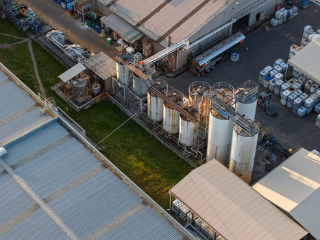 Melbourne VIC Australia 22 September 2026 Aerial view of industrial factories in Kilsyth with large storage tanks metal rooftops and a tanker truck in the yard. Melbourne VIC Australia 22 September 2026 Aerial view of industrial factories in Kilsyth with large storage tanks metal rooftops and a tanker truck in the yard.