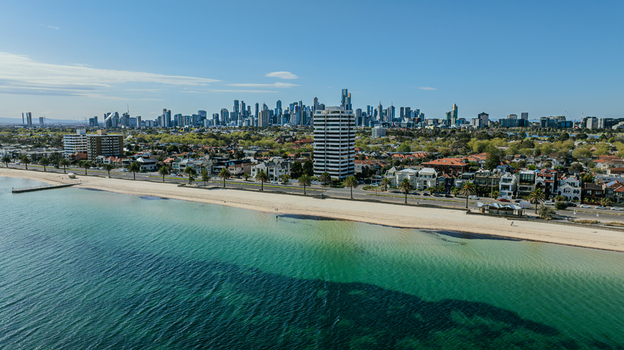 Aerial view of Middle Park Beach with the Melbourne skyline in the background featuring sandy shores clear turquoise water and coastal buildings in Middle Park Victoria Australia. Aerial view of Middle Park Beach with the Melbourne skyline in the background featuring sandy shores clear turquoise water and coastal buildings in Middle Park Victoria Australia.