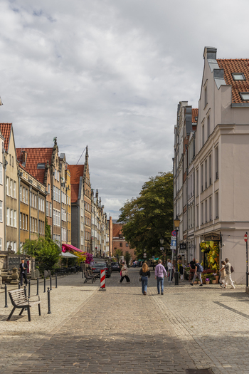 Gdansk Poland 07 September 2026 View of a cobblestone street in the historic old town lined with colorful buildings with people walking along the sidewalk under a cloudy sky. Gdansk Poland 07 September 2026 View of a cobblestone street in the historic old town lined with colorful buildings with people walking along the sidewalk under a cloudy sky.