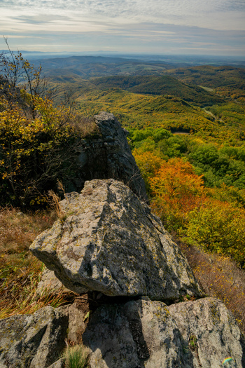 Aerial view of Sitno in Stiavnicke Vrchy with rocky outcrops overlooking the vast autumn forests and rolling hills in Ilija Banska Bystrica Region Slovakia.