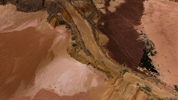 Aerial view of the salt lakes and industrial patterns near Useless Loop showcasing vibrant mineral deposits textured sand and earth tones in Kalbarri Western Australia Australia. Aerial view of the salt lakes and industrial patterns near Useless Loop showcasing vibrant mineral deposits textured sand and earth tones in Kalbarri Western Australia Australia.