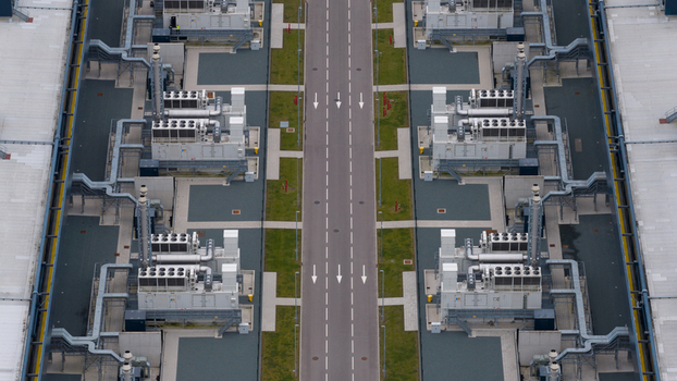 Aerial view of the Agriport industrial facility featuring cooling units and ventilation systems along a central road in Middenmeer Noord Holland Netherlands. Aerial view of the Agriport industrial facility featuring cooling units and ventilation systems along a central road in Middenmeer Noord Holland Netherlands.