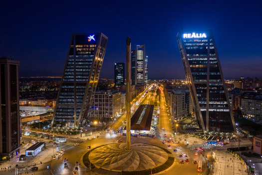 Aerial view of Plaza Castilla featuring the iconic Puerta de Europa towers illuminated at night with city traffic flowing through the roundabout in Madrid Comunidad de Madrid Spain. Aerial view of Plaza Castilla featuring the iconic Puerta de Europa towers illuminated at night with city traffic flowing through the roundabout in Madrid Comunidad de Madrid Spain.