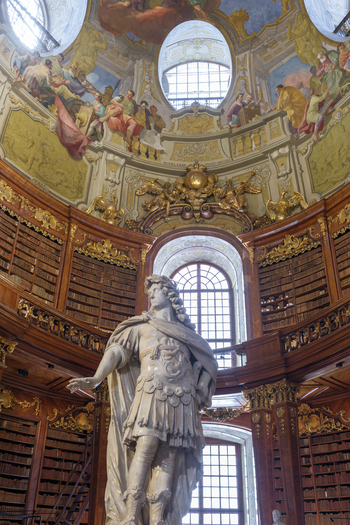 Wien Austria 26 April 2026 View of the Austrian National Library featuring the marble statue of Emperor Charles VI ornate wooden bookshelves and frescoed dome ceiling. Wien Austria 26 April 2026 View of the Austrian National Library featuring the marble statue of Emperor Charles VI ornate wooden bookshelves and frescoed dome ceiling.