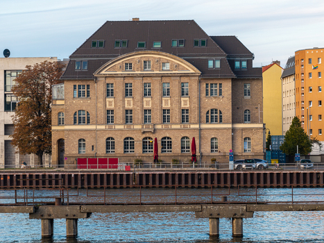 Aerial view of the historic Spreespeicher Promenade building situated along the Spree river waterfront with a pier in the foreground in Berlin Berlin Germany. Aerial view of the historic Spreespeicher Promenade building situated along the Spree river waterfront with a pier in the foreground in Berlin Berlin Germany.