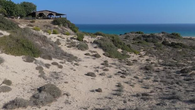 Aerial view of coastal dunes and restaurant in Northern Cyprus.