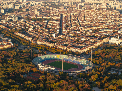 Aerial view of Vasil Levski National Stadium surrounded by lush autumn trees and the urban cityscape of Sofia during golden hour. Sofia Sofia City Province Bulgaria. Aerial view of Vasil Levski National Stadium surrounded by lush autumn trees and the urban cityscape of Sofia during golden hour. Sofia Sofia City Province Bulgaria.