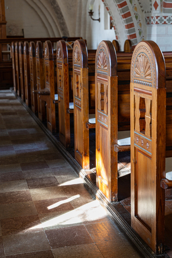 View of wooden pews inside a historic church on the Hindsholm peninsula in Kerteminde Municipality Denmark. View of wooden pews inside a historic church on the Hindsholm peninsula in Kerteminde Municipality Denmark.