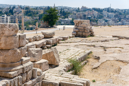 View of the ancient stone ruins at the Amman Citadel with the city skyline in the background Amman Amman Governorate Jordan.