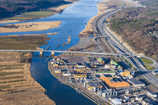 Aerial view of the Bohus industrial area situated along the Gota alv river with a bridge highway and railway infrastructure in Ale Vastra Gotaland County Sweden. Aerial view of the Bohus industrial area situated along the Gota alv river with a bridge highway and railway infrastructure in Ale Vastra Gotaland County Sweden.