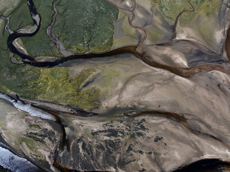 Aerial view of Findhorn Bay showing winding water channels through sandbanks and green marshland Findhorn Scotland United Kingdom. Aerial view of Findhorn Bay showing winding water channels through sandbanks and green marshland Findhorn Scotland United Kingdom.