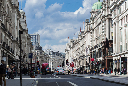 London United Kingdom 10 May 2019 View of Regent Street with historic neoclassical architecture bustling sidewalks pedestrians and traffic under a blue sky. London United Kingdom 10 May 2019 View of Regent Street with historic neoclassical architecture bustling sidewalks pedestrians and traffic under a blue sky.