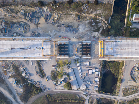 Aerial view of a bridge under construction with heavy machinery steel beams and concrete structures visible in the industrial landscape of Istanbul Istanbul Turkiye.