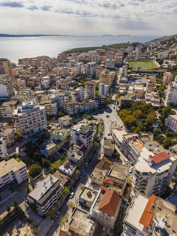 Aerial view of Saranda city with dense urban buildings and coastal landscape along the Ionian Sea in Saranda Vlore County Albania. Aerial view of Saranda city with dense urban buildings and coastal landscape along the Ionian Sea in Saranda Vlore County Albania.