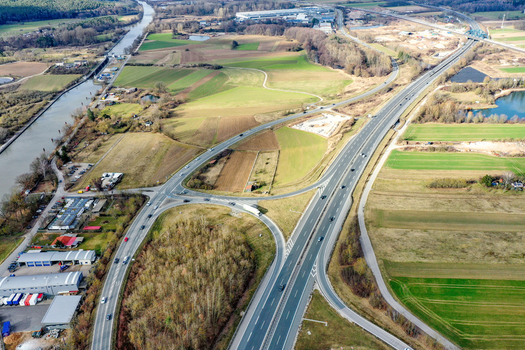 Aerial view of the highway interchange and the Main Donau Kanal surrounded by agricultural fields and industrial areas in Forchheim Bavaria Germany. Aerial view of the highway interchange and the Main Donau Kanal surrounded by agricultural fields and industrial areas in Forchheim Bavaria Germany.
