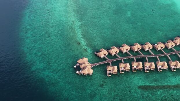 Aerial view of overwater bungalows in a turquoise lagoon Maldives. Aerial view of overwater bungalows in a turquoise lagoon Maldives.