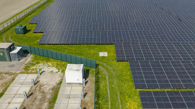 Aerial view of battery storage and mobile container charging at De Dijken Solar Park near Warmenhuizen supporting grid balance renewable energy and flexible power use. Aerial view of battery storage and mobile container charging at De Dijken Solar Park near Warmenhuizen supporting grid balance renewable energy and flexible power use.