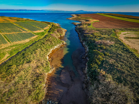 Aerial view of the vivid green fields meeting the blue sea along the rugged Istrian coastline a symphony of nature s palette Istria County Croatia. Aerial view of the vivid green fields meeting the blue sea along the rugged Istrian coastline a symphony of nature s palette Istria County Croatia.