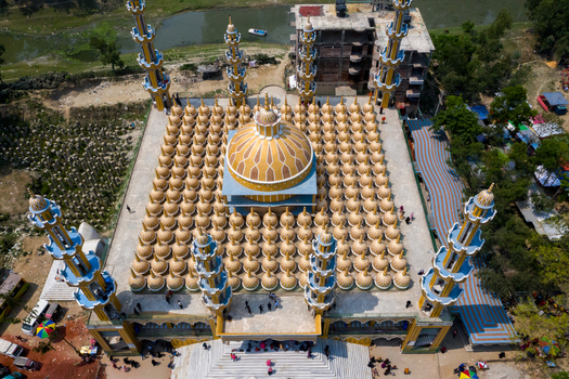 Aerial view of the grand 201 Dome Mosque stands majestically with its golden domes and intricate blue minarets Tangail Dhaka Division Bangladesh. Aerial view of the grand 201 Dome Mosque stands majestically with its golden domes and intricate blue minarets Tangail Dhaka Division Bangladesh.