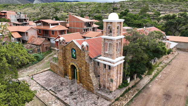 Torotoro Potosi Department Bolivia 29 September 2026 Aerial view of the historic stone church in Torotoro featuring a bell tower terracotta roofs and rural landscape.