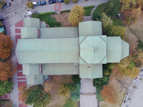 Aerial view of the historic Saint Sofia Church featuring a green metal roof and octagonal dome surrounded by autumn trees and paved walkways in Sofia Sofia City Province Bulgaria.