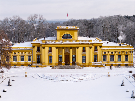 Aerial view of the yellow Traku Voke Manor surrounded by snow covered grounds and frosted trees in Vilnius Vilniaus apskritis Lithuania.