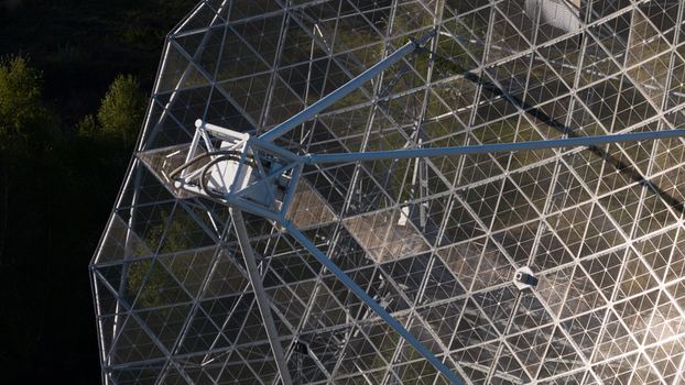 Aerial view of the Radiotelescoop showing its complex metal lattice structure and parabolic dish surrounded by lush green trees Dwingeloo Drenthe Netherlands.