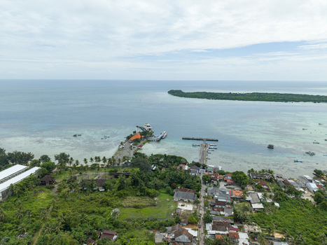 Aerial view of the karimunjawa ferry harbor with boats docked at the pier surrounded by lush greenery and the tranquil sea Karimunjawa Jawa Tengah Indonesia. Aerial view of the karimunjawa ferry harbor with boats docked at the pier surrounded by lush greenery and the tranquil sea Karimunjawa Jawa Tengah Indonesia.