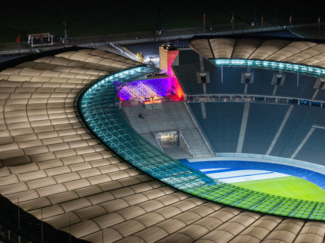 Berlin Germany 26 September 2026 Aerial view of the illuminated Olympiastadion Berlin at night showcasing its iconic roof structure and stadium seating.