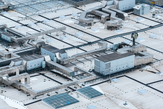 Aerial view of the rooftop of CH Targowek shopping center featuring extensive HVAC ventilation systems and skylights in Warsaw Masovian Voivodeship Poland. Aerial view of the rooftop of CH Targowek shopping center featuring extensive HVAC ventilation systems and skylights in Warsaw Masovian Voivodeship Poland.