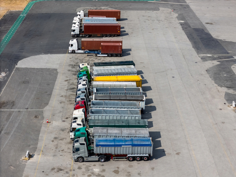Aerial view of long haul trucks parked in rows in a logistics yard in Alges Lisbon Portugal.