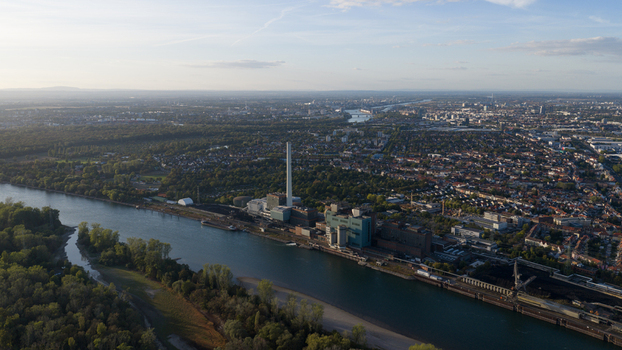 Aerial view of the Grosskraftwerk Mannheim power plant on the Rhine river surrounded by industrial infrastructure and urban areas in Mannheim Baden Wurttemberg Germany.
