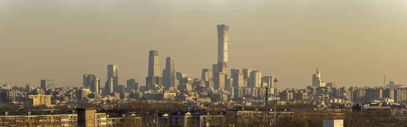 View of the Beijing CBD skyline featuring the China Zun tower and modern skyscrapers under a hazy golden sky in Beijing Beijing China. View of the Beijing CBD skyline featuring the China Zun tower and modern skyscrapers under a hazy golden sky in Beijing Beijing China.