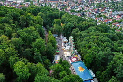 Forchheim Germany 25 July 2025 Aerial view of the Annafest fairground with its Ferris wheel and colorful stalls nestled within the lush green Kellerwald forest. Forchheim Germany 25 July 2025 Aerial view of the Annafest fairground with its Ferris wheel and colorful stalls nestled within the lush green Kellerwald forest.